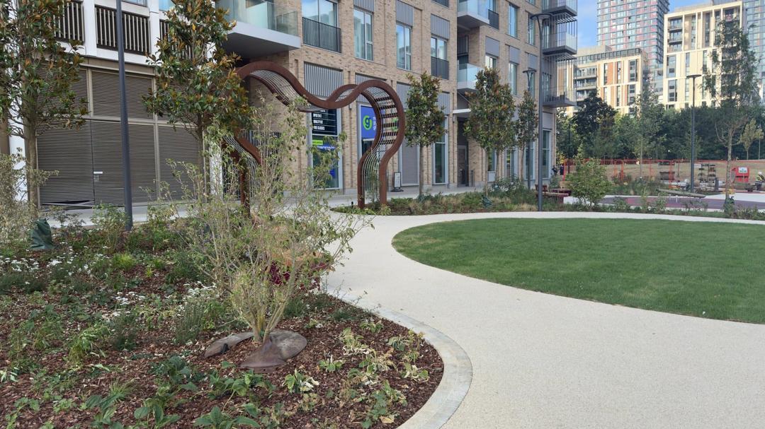 Belvedere Park in East Village, with new planting, a curved path and a steel arch